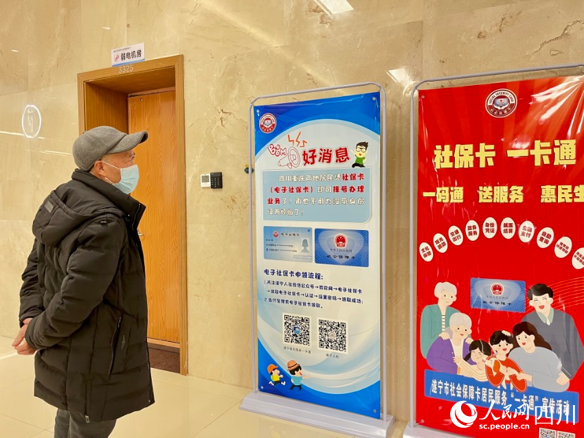 遂寧、潼南聯合建設的“一卡通一碼通”平臺，市民通過展板正在了解相關辦理流程。人民網朱虹攝