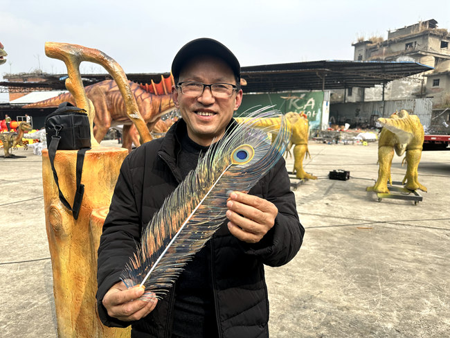 劉俊才和他剪制的“雀之靈”羽毛。人民網記者 王波攝