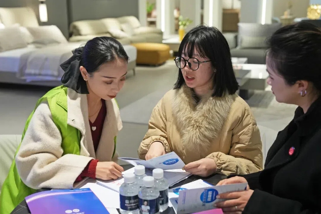 工作人員講解“親清在線宜商碼”。彭州市發展和改革局供圖