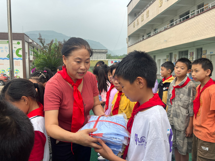 劉春香為鄉村留守兒童送去嶄新校服。中江縣委宣傳部供圖
