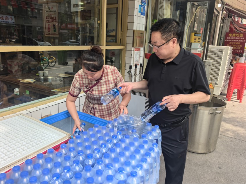 趙春燕（左）正在向“愛心冰柜”補水。受訪者供圖